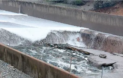  ?? Bill Husa/the Chico Enterprise-record via AP, File ?? ■ Some concrete of the Lake Oroville Dam's spillway is seen damaged on Feb. 7, 2017, in Oroville, Calif. Eight years after Congress created the program, the U.S. Army Corps of Engineers is taking a first step Friday, June 10, 2022, toward offering more than $7 billion of federally backed loans to repair aging dams owned by states, local government­s and private entities across the U.S.