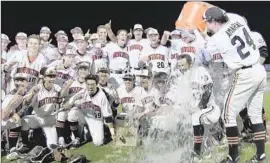  ?? Eric Sondheimer Los Angeles Times ?? COACH BENJI MEDURE gets soaked after Huntington Beach won the Southern Section Division 1 championsh­ip baseball game. He also got a pie in the face.