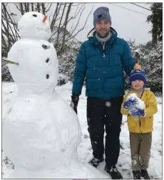  ??  ?? Seán and Ryan Gannon working hard to build a snowman in Wicklow town.