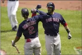  ?? JULIO CORTEZ — THE ASSOCIATED PRESS ?? The Boston Red Sox’s J.D. Martinez, right, is greeted near home plate by Xander Bogaerts after hitting a solo home run off Baltimore Orioles starting pitcher Jorge Lopez during the third inning Sunday in Baltimore.