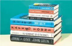  ??  ?? Mini-book versions of works by John Green compared with their full-size counterpar­ts from the Dutton imprint from Penguin Random House.