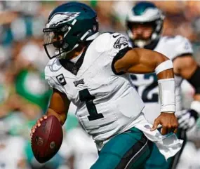  ?? JESS RAPFOGEL/GETTY IMAGES ?? Eagles quarterbac­k Jalen Hurts threw for 319 yards and four touchdowns — on a bad left knee — to beat the Commanders.