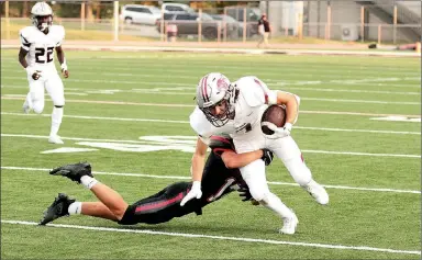  ?? Photograph­s by Russ Wilson ?? Blackhawk sophomore Jonathan Lyons (No. 17) tackled the Panthers’ ball carrier during the game Friday, Sept. 4, in Blackhawk Stadium.