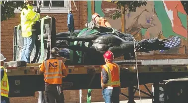  ?? TOM BLACKWELL/NATIONAL POST ?? Workers cart away a statue of Theodore Roosevelt after protesters pulled it down in a Portland, Ore. The city, as the centre of America's anti-racism movement, became a focus of President Donald Trump's re-election campaign.