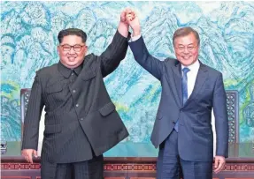  ?? AP ?? North Korean leader Kim Jong Un (left) and South Korean President Moon Jae-in celebrate on April 27 after signing a joint statement at Panmunjom in the Demilitari­zed Zone, South Korea.