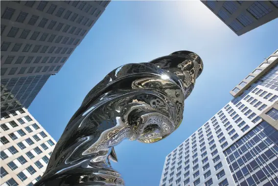 ?? Photos by Paul Chinn / The Chronicle ?? This 92-foot-high stainless steel sculpture by artist Lawrence Argent, a modernist version of the “Venus de Milo,” dominates the central piazza of Trinity Place.
