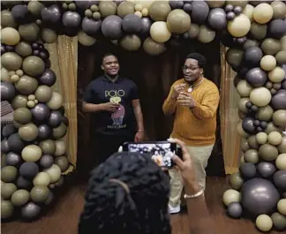  ?? ?? Davion Holmes, right, interviews Bob Lee during the Black Heritage Ball at Illinois State University on Feb. 25 in Normal. The ball was sponsored by the Black Students Union and covered by Onyx Connect.