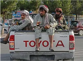  ??  ?? Terrorist state: Taliban fighters, now in control of Afghanista­n, on patrol in Kabul