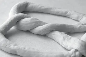  ?? Tribune News Service ?? ■ Putting the twist on homemade soft-pretzel dough.