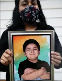  ?? Photo for The Washington Post by Allison V. Smith ?? Priscilla Boatman holds a photo of her son J.J., who died of COVID-19.