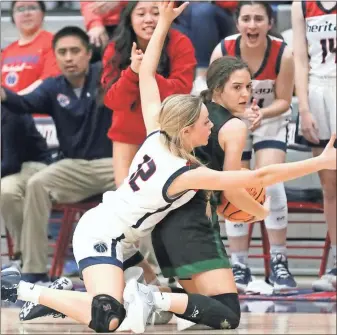  ?? Danielle Pickett, General Photograph­y ?? Heritage’s Bailee Hollis gets encouragem­ent from the bench as she goes all out on defense during the Lady Generals’ first-round playoff victory against North Hall.