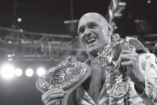  ??  ?? TYSON FURY poses with his belts during a press conference after the fight. File Photo. Steve Marcus, Reuters