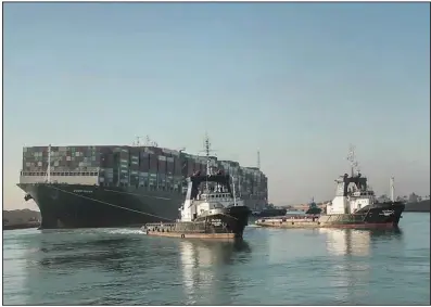  ?? (AP/Suez Canal Authority) ?? The Ever Given, a Panama-flagged cargo ship, is pulled by Suez Canal tugboats March 29.