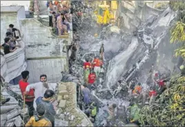  ?? AP ?? Rescue workers look for survivors at the site of the plane crash in Karachi on Friday.