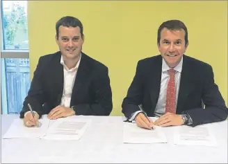  ?? CP PHOTO ?? Nova Scotia Health Minister Randy Delorey, left, and Nova Scotia’s regional representa­tive in the federal cabinet, Scott Brison sign a bilateral heath deal in Halifax on Thursday.