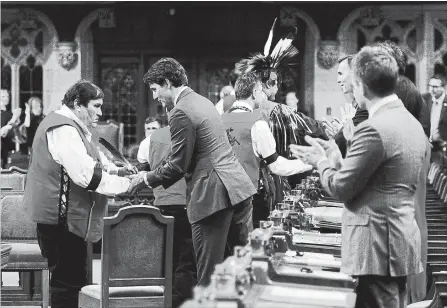  ?? SEAN KILPATRICK THE CANADIAN PRESS ?? Prime Minister Justin Trudeau shakes hands with ceremony participan­ts after delivering a statement of exoneratio­n on behalf of the Government of Canada to the Tsilhqot'in Nation and the descendant­s of six Tsilhqot'in chiefs in the House of Commons on...