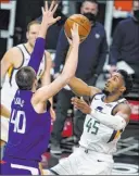  ?? Marcio Jose Sanchez The Associated Press ?? Jazz guard Donovan Mitchell lines up a shot against Clippers center Ivica Zubac in the first half of Utah’s 114-96 win Wednesday at Staples Center.