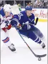  ?? Canadian Press photo ?? New York Rangers defenceman Brady Skjei (76) and Toronto Maple Leafs centre Leo Komarov (47) vie for control of the puck during second period NHL hockey action in Toronto on Saturday.