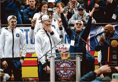  ?? Brian A. Pounds/Hearst Connecticu­t Media ?? UConn Huskies Men’s basketball Head Coach Dan Hurley reacts with arms raised as Alex Karaban is introduced to speak at the rally celebratin­g the Huskies’ second straight national championsh­ip outside the XL Center on Saturday.