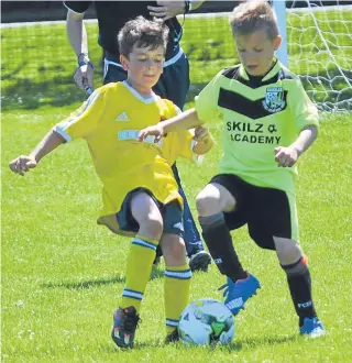  ??  ?? More Age 9 action from Douglas Youth (black socks) against Ferry.