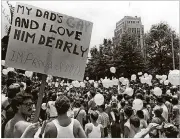  ?? NANCY MANGIAFICO / THE ATLANTA JOURNAL-CONSTITUTI­ON ?? A marcher holds a sign in support of his father during a Gay Pride march and rally at the State Capitol in Atlanta on June 26, 1982.