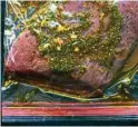  ?? David Malosh / New York Times ?? Flank steak marinates in a Worcesters­hire sauce mix.