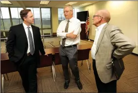  ?? NWA Democrat-Gazette/ANDY SHUPE ?? Nelson Peacock (left) speaks Tuesday with Rob Smith, and Scott Van Laningham, both of the Northwest Arkansas Council, after being announced as the new president and CEO of the council.