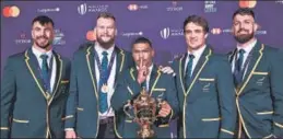  ?? AFP ?? South Africa's Rugby World Cup winners pose with the trophy in Paris on Monday.