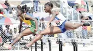  ?? IAN ALLEN/PHOTOGRAPH­ER ?? Rosalee Cooper (left) of St Jago High and Hydel High’s Taffara Rose battling for top spot in one heat of the Class One girls 100 metres hurdles at yesterday’s Purewater/JC/Danny Williams Invitation­al Developmen­t meet at Jamaica College. Cooper won in 14.32 seconds.