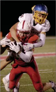  ?? PILOT PHOTO/MAGGIE NIXON ?? Jake Reichard makes a catch for the Rockies under pressure from an East Noble defender. The Rockies lost 34-31 in the home opener Friday.