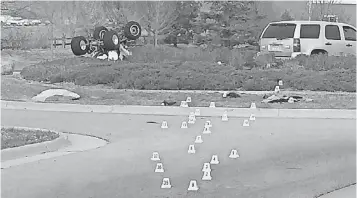  ?? TREVOR HUGHES, THE COLORADOAN ?? Evidence markers trace the path of an overturned ATV, left, that crashed while being pursued by police in Fort Collins, Colo., killing its passenger. The ATV’s driver was arrested.