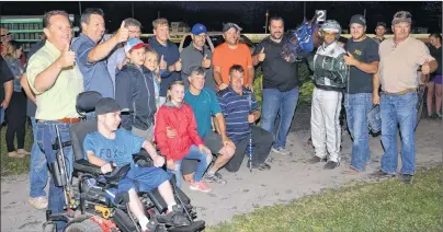  ?? JASON SIMMONDS/JOURNAL PIONEER ?? The ownership group of Do Over Hanover – Rene Allard, holding the head of the horse; Steven MacRae, front left, and members of Red Isle Racing – pose with driver Marc Campbell, trainer Chris MacKay, right, and Jordan MacKay, second right, who is...