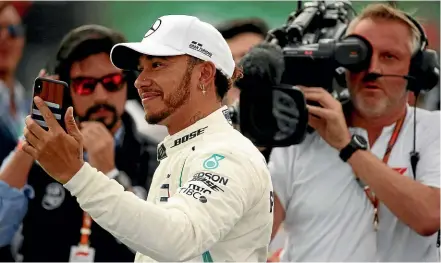  ?? AP ?? Mercedes driver Lewis Hamilton celebrates after becoming Formula One champion at the Mexico Grand Prix.