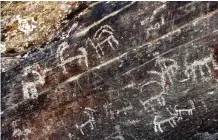  ??  ?? Ancient engravings of ibex deer are seen in the hills outside the town of Khomein.