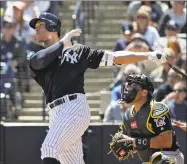  ?? Chris O'Meara / Associated Press ?? The Yankees’ Aaron Judge follows the flight of his RBI double off Pirates starting pitcher Joe Musgrove during the first inning of a spring training game Thursday in Tampa, Fla. Brett Gardner scored on the hit. Catching for the Pirates is Francisco...