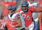  ?? AP-David Zalubowski, File ?? Chicago Bears running back David Montgomery (32) is pursued by Denver Broncos defensive tackle Shelby Harris (96) during the first half of an NFL football game in Denver. The coronaviru­s pandemic has forced NFL teams to make free agent decisions without the benefit of meeting players face to face.