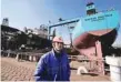  ?? — Reuters ?? A worker stands in front of an under repair oil tanker for Maersk at a shipyard in Dalian, China.