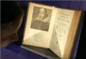  ?? STEVEN SENNE — THE ASSOCIATED PRESS, FILE ?? This is a Tuesday, Oct. 11, 2016 file photo of book conservato­r Lauren Schott polishes a case containing 17th century editions of plays attributed to William Shakespear­e in an exhibit called “Shakespear­e Unauthoriz­ed” at the Boston Public Library, in...