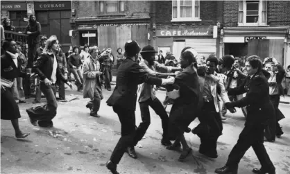  ?? Photograph: Gary Weaser/Getty Images ?? Anti-fascist protesters scuffle with police in New Cross, Lewisham, in 1977. Police spied on children involved with anti-fascist groups that faced down the far right in the 1970s.