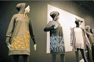  ?? Eric Risberg Associated Press ?? A KNEE-LENGTH hoodie, far left, was made for Muslim girls participat­ing in a scout program.