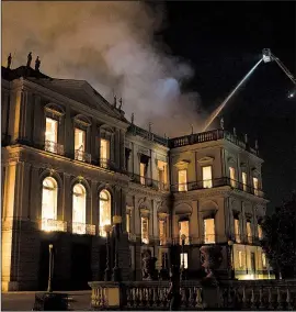  ?? AP/LEO CORREA ?? Firefighte­rs work late Sunday as flames engulf Brazil’s National Museum in Rio de Janeiro. On Monday, protesters gathered outside the gates of the 200-year-old museum and demanded to see the damage, while officials feared that the blaze had destroyed most of the objects in the burned-out main building.