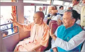  ?? HT ?? ▪ Chief minister Yogi Adityanath and Uttarakhan­d CM Trivendra Singh Rawat taking a brief ride in one of the 51 Kumbh shuttle buses that they flagged off outside UP CM’s official residence on Monday