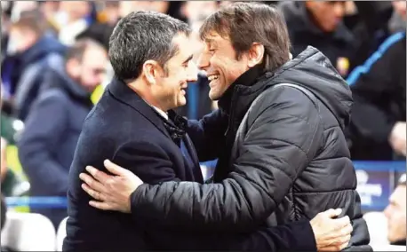  ?? BEN STANSALL/AFP ?? Chelsea manager Antonio Conte (right) and Barcelona coach Ernesto Valverde greet each other before their Champions League round of 16 first leg at Stamford Bridge in London on February 20.