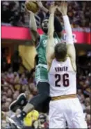  ?? TONY DEJAK — THE ASSOCIATED PRESS ?? Boston’s Jaylen Brown (7) shoots over Cleveland’s Kyle Korver (26) during Game 4 of the Eastern Conference finals Tuesday in Cleveland.