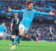  ?? — AFP ?? Manchester City’s David Silva celebrates after scoring the opening goal during their English Premier League match against Fulham at the Etihad Stadium on Saruday.