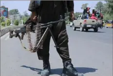  ?? AFP via Getty Images ?? A Taliban fighter stands guard on a street Saturday in Herat, Afghanista­n. The Taliban continued its push across Afghanista­n and now controls most of the country.