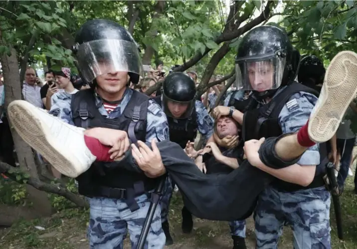 ?? © Shamil Zhumatov/rtr ?? Ordetroepe­n arresteren een manifestan­t bij protest in Moskou, in juni, tegen de aanhouding van de journalist Ivan Golunov.