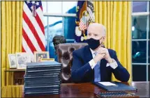  ??  ?? In this file photo, President Joe Biden waits to sign his first executive order in the Oval Office of the White House in Washington. (AP)