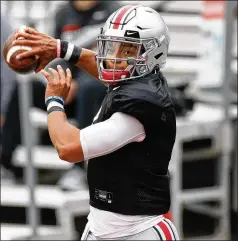  ?? JAY LAPRETE/ AP ?? Ohio State’s Justin Fields, the formerGeor­gia Bulldog, could’ve opted out of this pandemic- shortened season butwanted onemore shot at the Heisman Trophy and a national title. “He truly doesn’twant to leave a stone unturned,” said Buckeyes quarterbac­ks coach Corey Dennis.