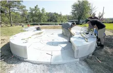  ?? JULIE JOCSAK/STANDARD STAFF ?? Stone carvers from Smith and Barber Sculpture Atelier work on the 22-tonne First Nations Peace Monument at the DeCew House Heritage Park in Thorold on Tuesday. The completed monument will be unveiled during a ceremony on Oct. 7.